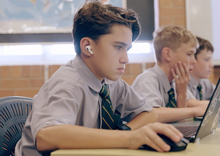 A few school students studying on their laptops