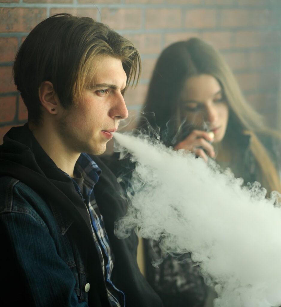Two young people vaping